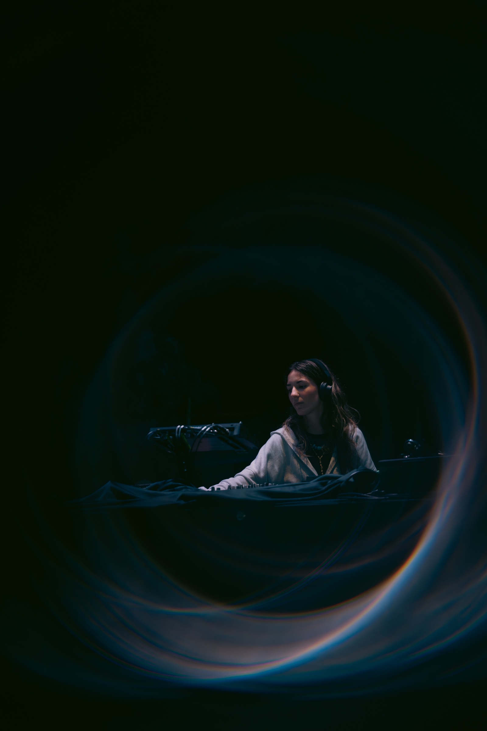 Claudia Coll DJing in a dimly lit booth